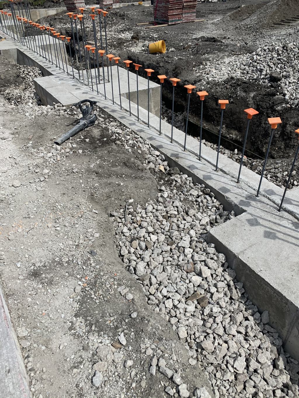 Reinforcing steel set in a footing trench over the compacted stone base
