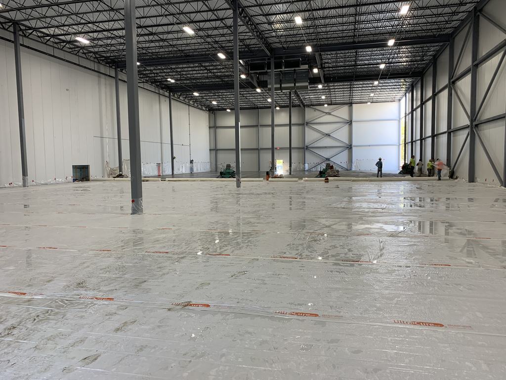 Wide view of the completed freezer interior showing structural steel columns and the insulated panel end wall