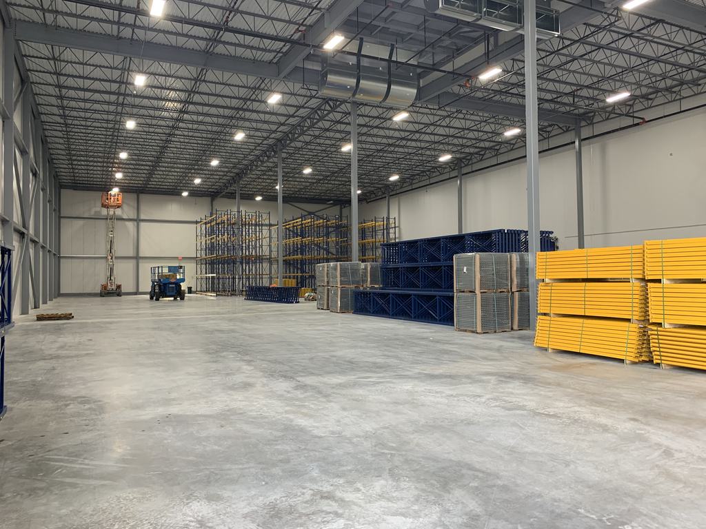 Pallet racking components staged on the finished freezer floor ahead of installation