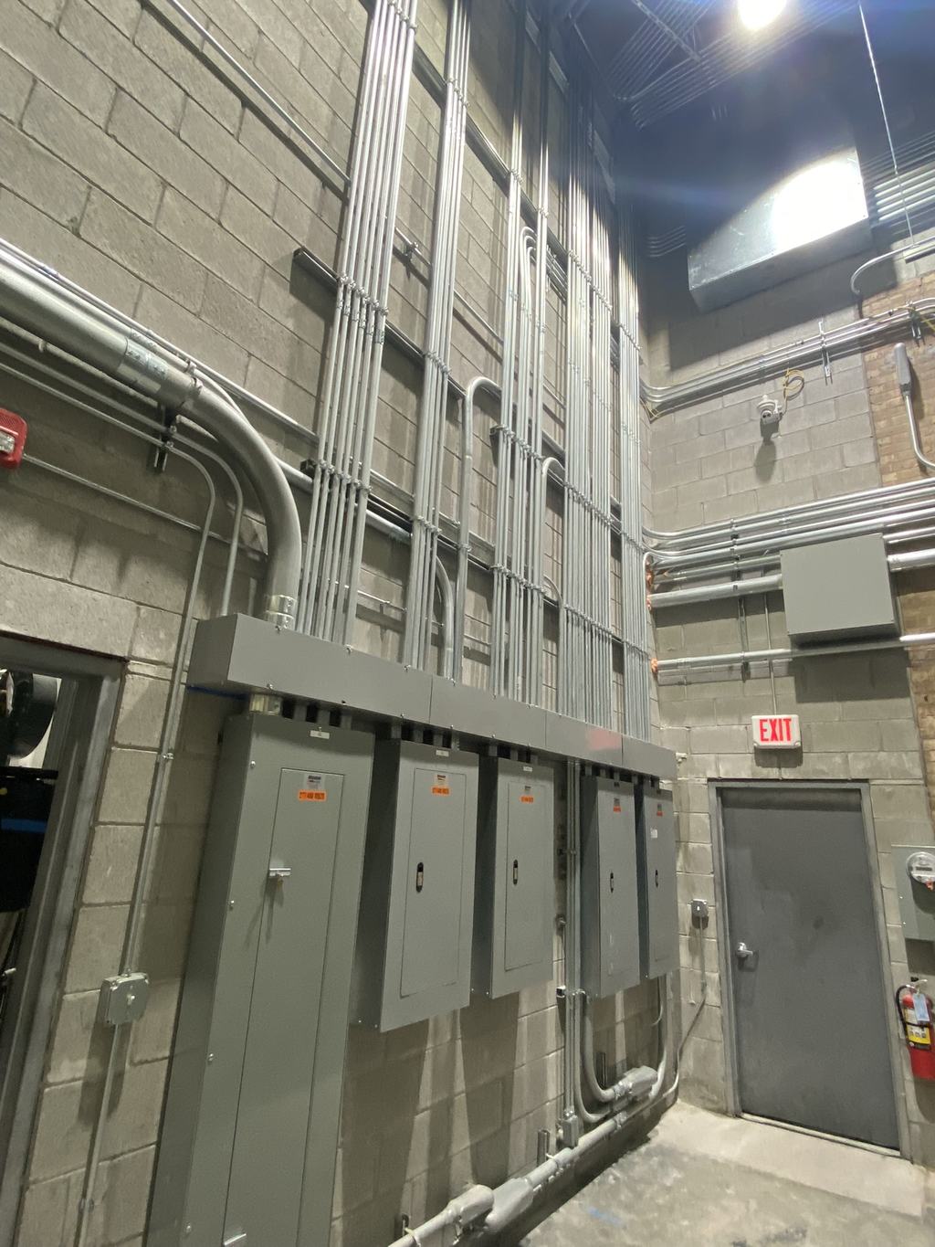 New primary electrical service equipment installed along an interior wall of the facility
