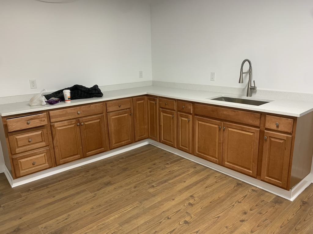 Renovated cafeteria area with new cabinetry, countertop, and sink