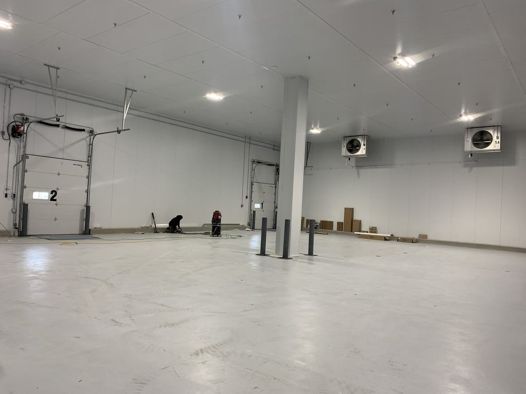Completed temperature-controlled bay with insulated panel walls and ceiling-mounted evaporators